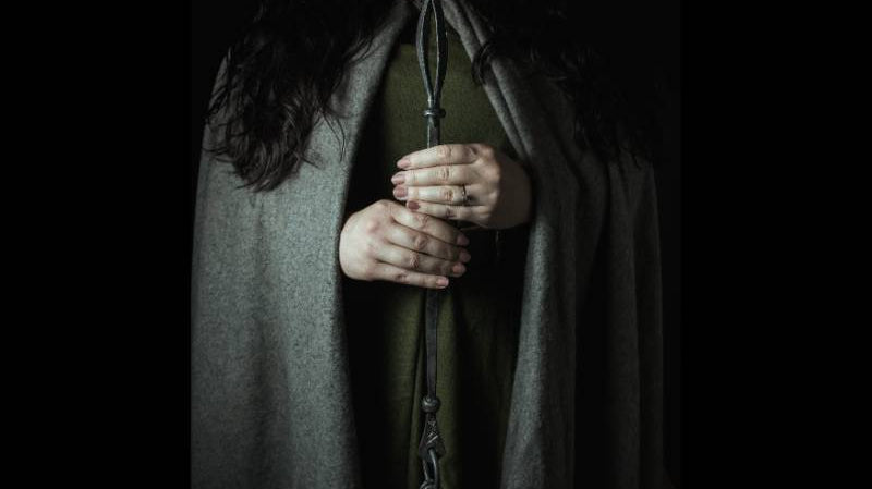 holding a völva staff