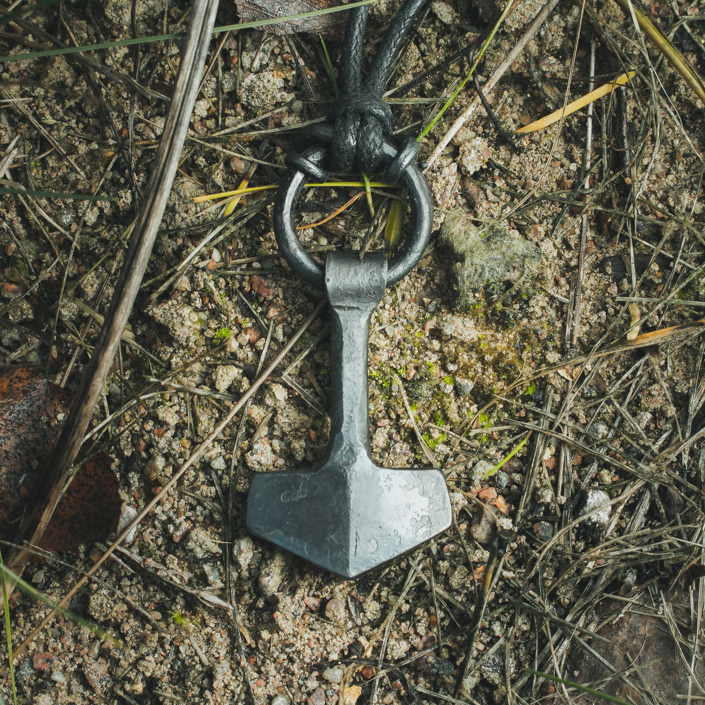 Close-up view of the detailing on the Mjolnir pendant.