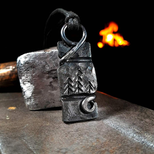 A close-up of a unique hand-forged forest pendant made with high-quality materials.