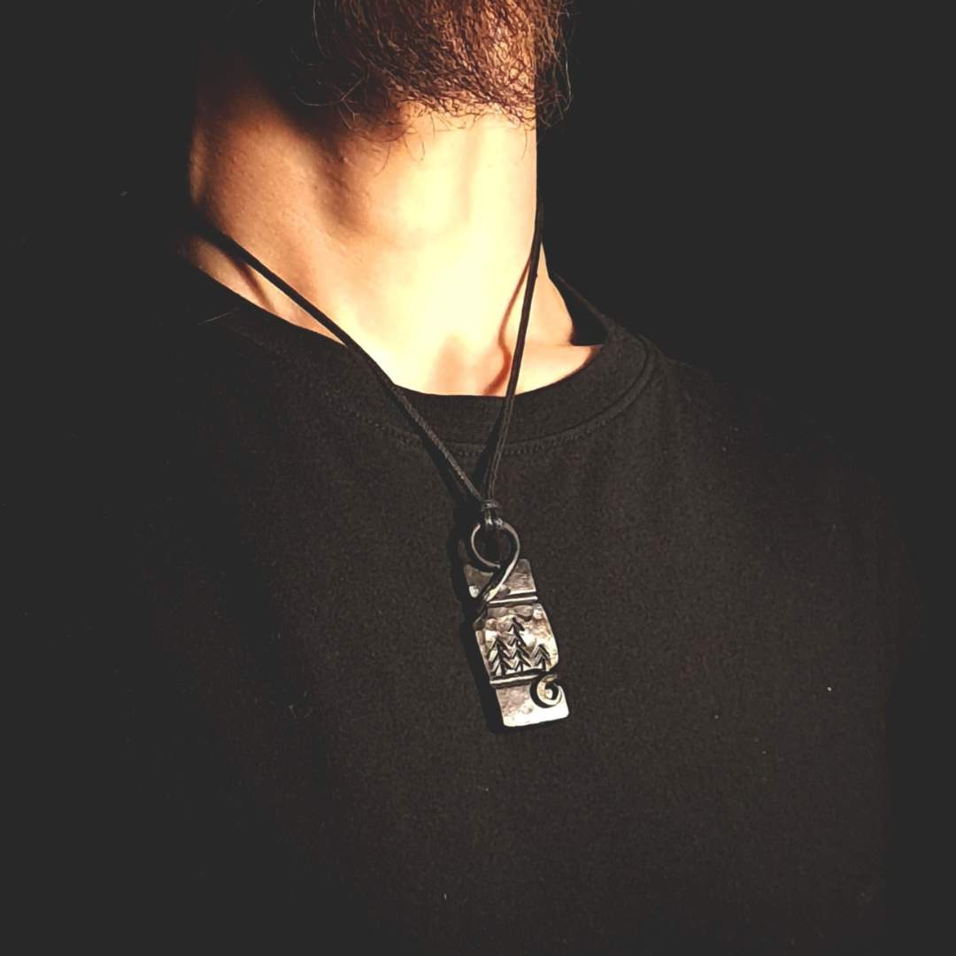 A person wearing the forest pendant, showing how it looks when worn.