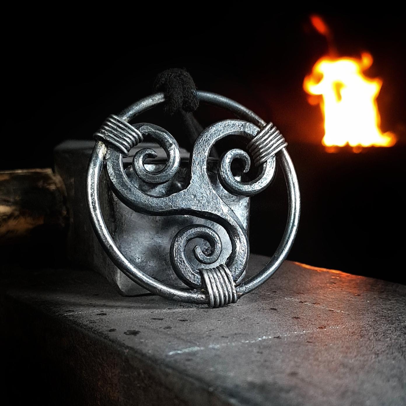 close up on a forged triskele pendant