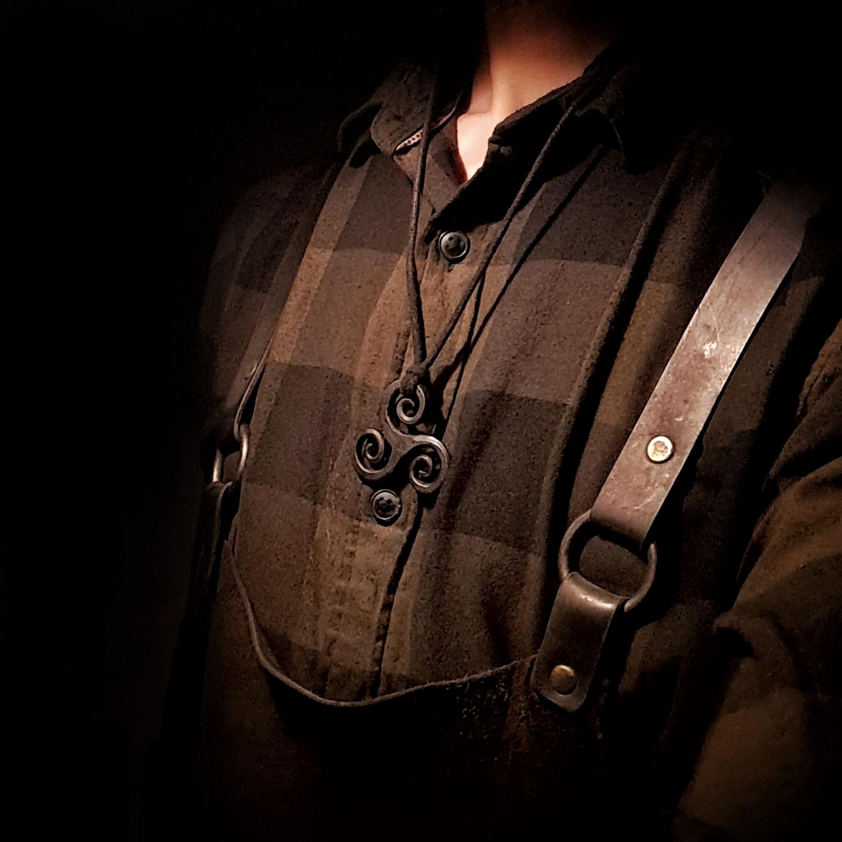 model wearing a triskele pendant in a different design