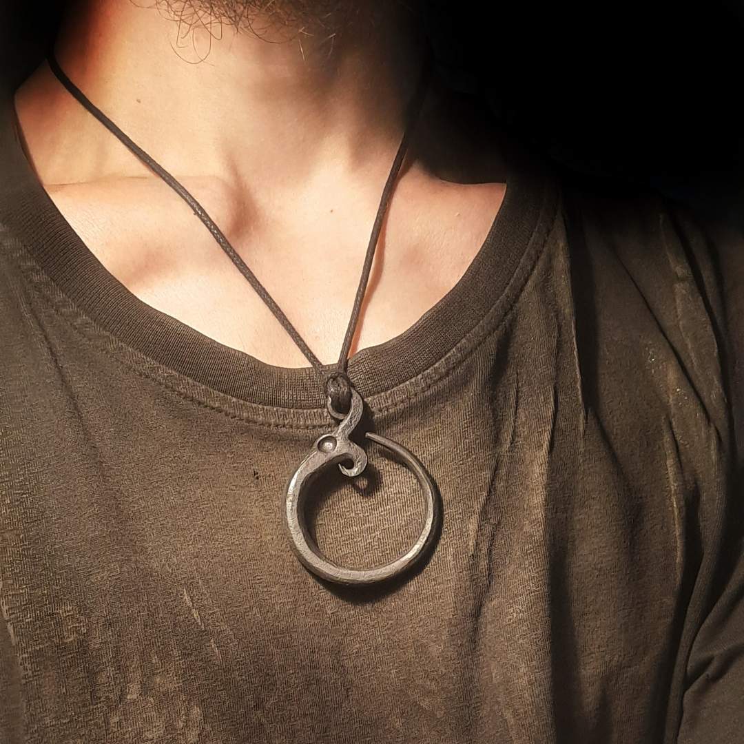 A model wearing the Midgard Serpent pendant, showing how it looks when worn.