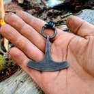 flint striker shaped as mjolnir in a hand