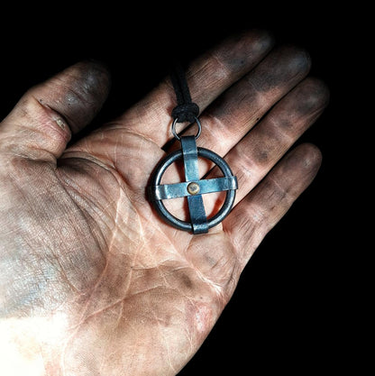 holding a sun cross pendant