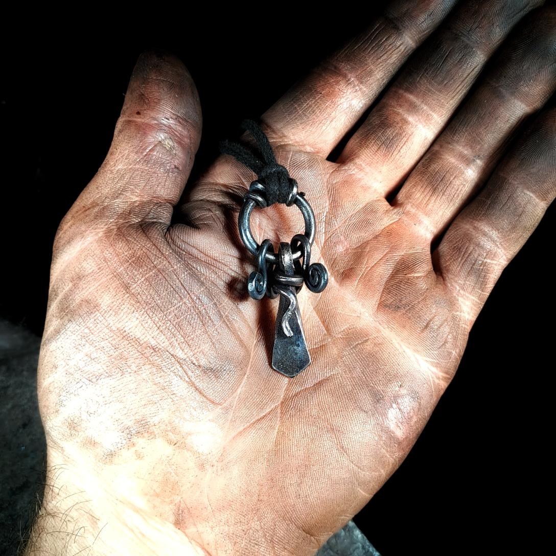 holding a völva pendant